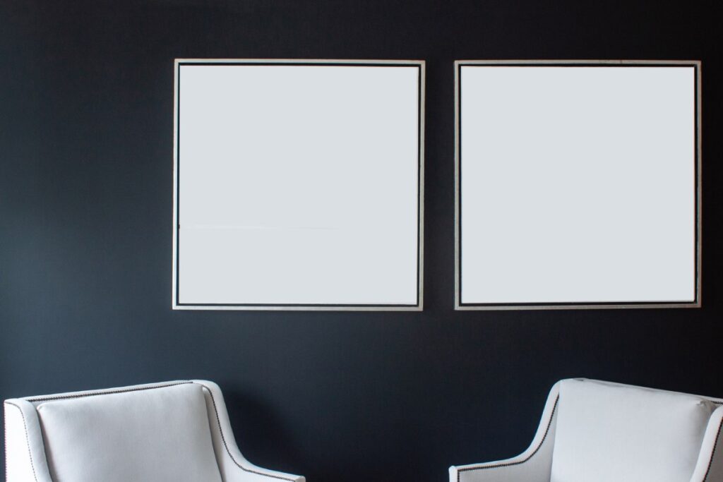 Two white canvases in floater frames on the wall